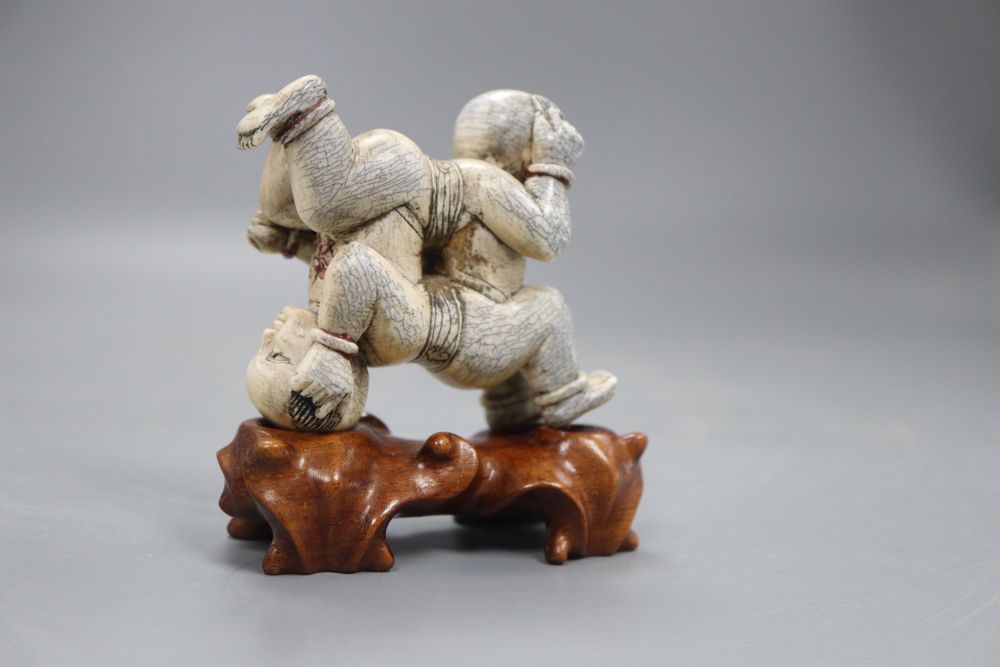 Two Chinese wooden stands (boys), height 9cm